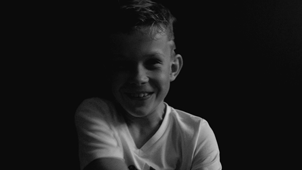 photo of a boy listening to music